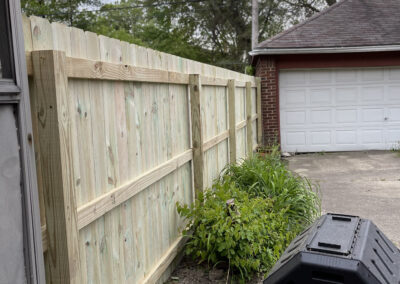 Narrow side yard with a wooden fence and garage