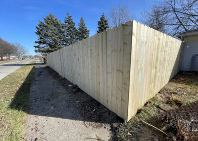 Wooden privacy fence along a residential sidewalk