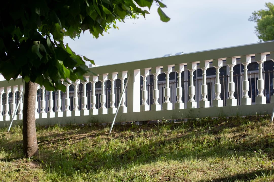 a white fence sitting in the middle of a field